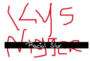 An image with writing saying "K Y S (N-word)", with the words "racial slur" overlayed on top of it.